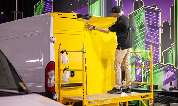 Brand Command installer wrapping a commercial van in the Apple Valley shop