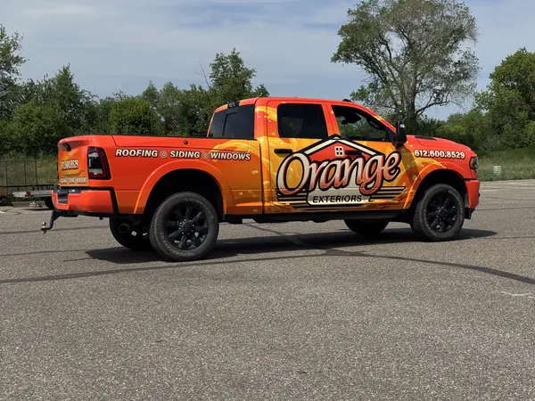 Orange Exteriors roofing and siding pickup truck wrap